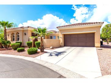 Beautiful one-story home featuring a tile roof, desert landscaping, and a two car attached garage at 23128 N Sol Mar Ct, Sun City West, AZ 85375