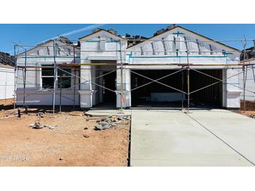 New construction home showcases scaffolding around the exterior, set to be completed soon at 5086 E Midnight Star Dr, San Tan Valley, AZ 85143
