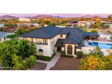 Stunning two-story home with mature landscaping, a pool, and a tile roof at 1501 N 67Th St, Mesa, AZ 85205