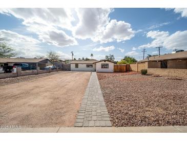 Charming single-story home with an expansive gravel front yard and gray paver pathway under a bright sunny sky at 1108 N Esther St, Tempe, AZ 85288
