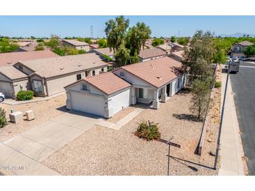 Charming single-story home with a well-maintained yard and a two-car garage in a friendly neighborhood at 11343 W Mccaslin Rose Ln, Surprise, AZ 85378