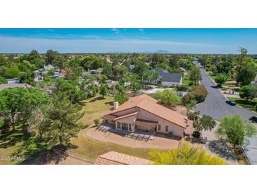 Expansive property showcasing a desert-landscaped yard and a charming single-story house with a terracotta roof at 1637 S Los Alamos Cir, Mesa, AZ 85204