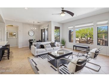 Bright living space with stylish furnishings, large windows, and an adjacent dining area, perfect for modern living at 16600 N Thompson Peak Pkwy # 2050, Scottsdale, AZ 85260