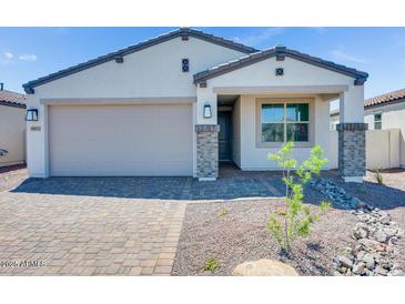 Charming single-story home with a two-car garage and professionally landscaped front yard at 18123 W Hiddenview Dr, Goodyear, AZ 85338