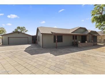 Charming single-story home with a well-maintained yard, garage, and inviting facade at 232 W San Angelo St, Gilbert, AZ 85233