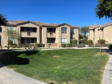 A spacious apartment complex with well-maintained landscaping and a lush green lawn at 29606 N Tatum Blvd # 276, Cave Creek, AZ 85331
