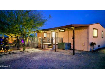 Inviting home exterior featuring porch with black railing, lighted entryway and desert landscaping at 29972 N Bryce Trl, San Tan Valley, AZ 85144