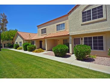 Charming two-story townhome featuring a well-manicured lawn and inviting curb appeal at 5808 E Brown Rd # 60, Mesa, AZ 85205