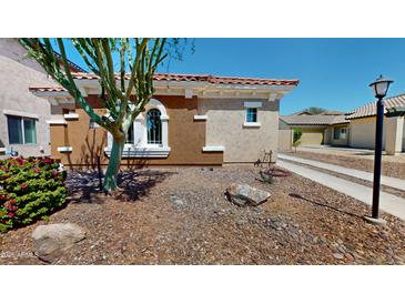 Beautiful, single-story home featuring desert landscaping, a tile roof, and an inviting facade at 7730 E Boise St, Mesa, AZ 85207