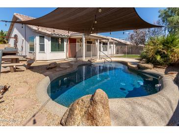 Inviting pool area with shade, perfect for relaxing and entertaining outdoors in a well-maintained backyard at 8757 W El Caminito Dr, Peoria, AZ 85345