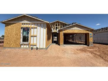 This image shows an exterior view of a house under construction, revealing its framing and initial structure at 11422 E Utah Ave, Mesa, AZ 85212