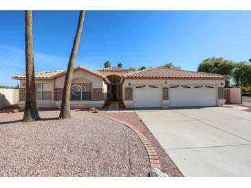Charming single-story home featuring a well-maintained yard and a spacious three-car garage at 2009 N 125Th Ave, Avondale, AZ 85392