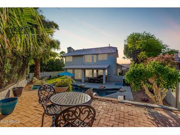Inviting backyard with a pool, patio, and mature landscaping creates an outdoor oasis at 21121 N 63Rd Dr, Glendale, AZ 85308