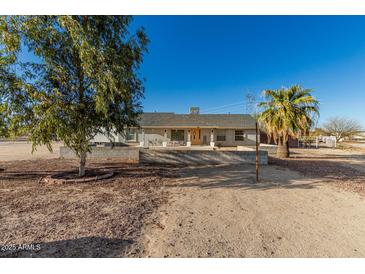 Charming single-story home with desert landscaping and a covered front porch perfect for relaxing at 22324 W Magnolia St, Buckeye, AZ 85326