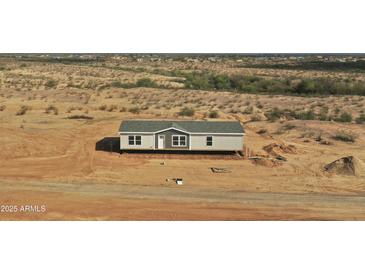 New build home showing gray exterior, complementing the tranquil desert scenery at 23139 W Duane Ln, Wittmann, AZ 85361