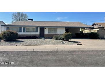 Single-story home featuring low maintenance landscaping, a covered area for parking, and blue trim at 3339 W Shaw Butte Dr, Phoenix, AZ 85029