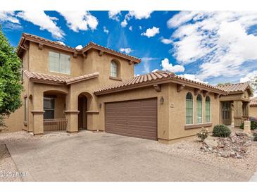 Two-story home with a tile roof, a two-car garage, and a charming front porch at 3940 E Geronimo St, Gilbert, AZ 85295