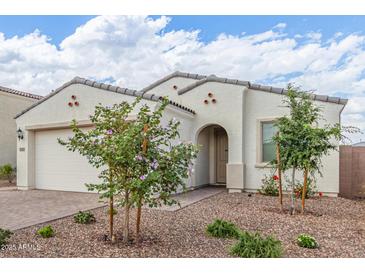 Charming single-story home with a neutral stucco facade, a tiled roof, and low-maintenance desert landscaping at 5312 W Hardtack Trl, Laveen, AZ 85339