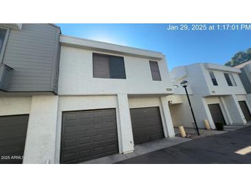 A townhome with an attached single-car garage and neutral-colored stucco exterior at 9209 N 59Th Ave # 206, Glendale, AZ 85302