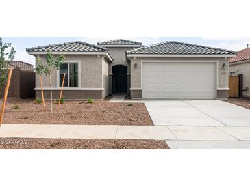 Charming single-story home with a two-car garage, neutral paint, and low-maintenance landscaping at 17761 W Getty Dr, Goodyear, AZ 85338
