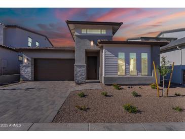 Charming single-Gathering home with a desert landscape and modern architecture, featuring a stone driveway at 21436 W Meadowbrook Ave, Buckeye, AZ 85396