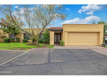 Charming home featuring mature landscaping, a private entrance and a spacious two-car garage at 2217 W Claremont St, Phoenix, AZ 85015