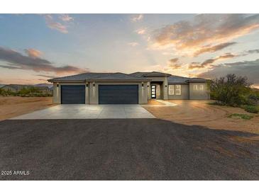 Beautiful home featuring a neutral color scheme, concrete driveway, and three-car garage at 31505 N 166Th Pl, Scottsdale, AZ 85262