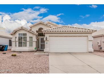 Charming single-Gathering home featuring a tile roof, desert landscaping, and a two-car garage at 3349 E Lavey Ln, Phoenix, AZ 85032