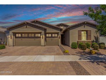 Charming single-story home featuring a three-car garage and brick paved driveway, enhanced by a lovely desert landscape at 4361 S Electron --, Mesa, AZ 85212
