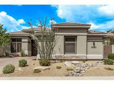 Charming single-story home with desert landscaping and a neutral color palette under a beautiful blue sky at 8220 E Mohawk Ln, Scottsdale, AZ 85255