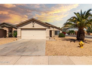 Charming single-story home featuring a low-maintenance desert landscape and a two-car garage at 8502 W Pierson St, Phoenix, AZ 85037