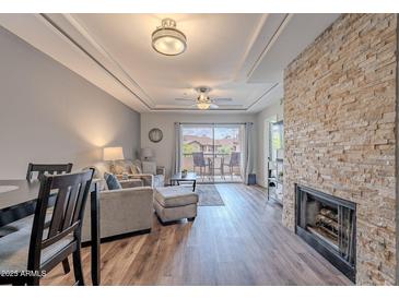 Cozy living room boasts a fireplace and a balcony at 9451 E Becker Ln # 2004, Scottsdale, AZ 85260