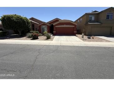Cozy single-story home with a two-car garage and well-maintained desert landscaping at 10247 W Hilton Ave, Tolleson, AZ 85353