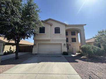 Charming two-story home with a neutral stucco exterior, a spacious two-car garage and low maintenance desert landscaping at 12571 W Clarendon Ave, Avondale, AZ 85392