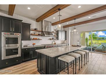 Modern kitchen featuring a large center island with seating at 17396 W Crawfordsville Dr, Surprise, AZ 85388
