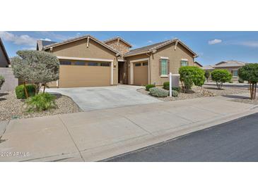 Charming single-story home featuring a two-car garage and low-maintenance landscaping at 23871 N 167Th Ln, Surprise, AZ 85387