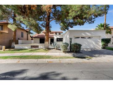 Charming single Gathering home with a desert landscaped front yard, tile roof and a two car garage at 250 E Barbarita Ave, Gilbert, AZ 85234