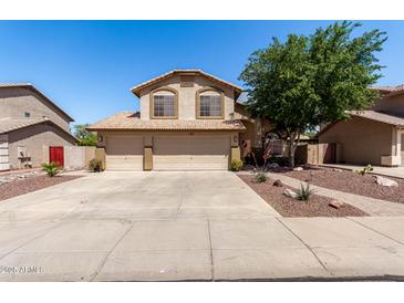 Charming two-story home featuring a three-car garage, desert landscaping, and a welcoming facade at 288 E Baylor Ln, Gilbert, AZ 85296
