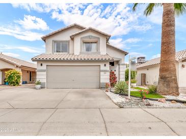 Charming two-story home featuring desert landscaping, two car garage, and neutral color palette at 3912 E Rockwood Dr, Phoenix, AZ 85050