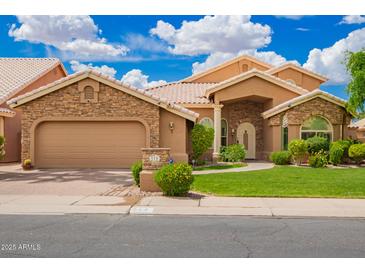Charming single-story home featuring a stone-accented facade, tile roof, and well-manicured landscaping at 518 S Bay Shore Blvd, Gilbert, AZ 85233