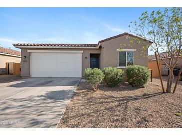 Charming single-story home featuring a two-car garage, low-maintenance landscaping and a desert-style front yard at 697 E Ruby Dr, Casa Grande, AZ 85122