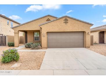Charming single-story home featuring a two-car garage and low-maintenance desert landscaping in a residential neighborhood at 951 E Jacob St, Chandler, AZ 85225
