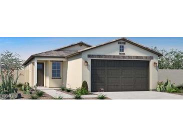 Single-story home featuring a neutral color scheme, a two-car garage, and low-maintenance desert landscaping at 14586 W Wood Dr, Surprise, AZ 85379