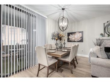 Stylish dining area with modern chandelier, seating for six, and natural light at 15252 N 100Th St # 1154, Scottsdale, AZ 85260