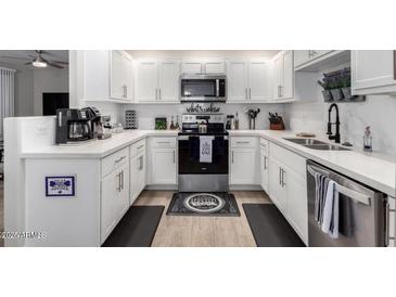 Bright kitchen features white cabinetry, stainless steel appliances, and modern countertops at 15252 N 100Th St # 1154, Scottsdale, AZ 85260