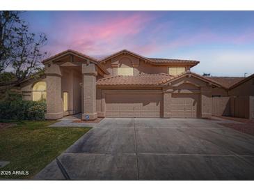 Exterior elevation of a two-story home with a three-car garage under a dusk sky at 514 E Vaughn Ave, Gilbert, AZ 85234