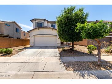 Charming two-story home featuring a neutral color palette, spacious garage, and mature trees at 15054 N 173Rd Dr, Surprise, AZ 85388