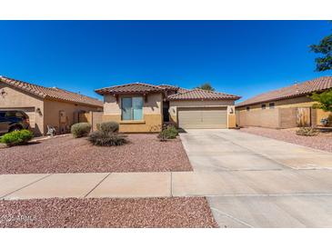 Inviting single-story home features a tile roof, two-car garage and desert landscaping for easy maintenance at 17290 N 170Th Ln, Surprise, AZ 85374