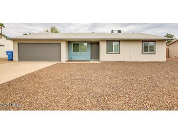 Charming single story home featuring a two car garage and xeriscape front yard at 2110 E Kathleen Rd, Phoenix, AZ 85022
