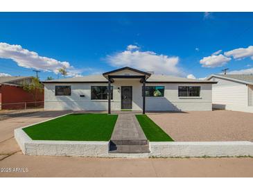 Charming single-story home with well-maintained lawn and inviting front porch at 3044 W Dahlia Dr, Phoenix, AZ 85029
